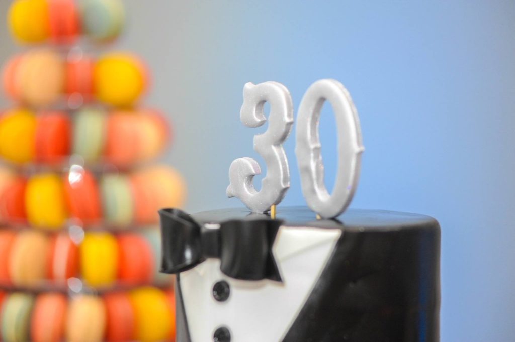 30th Birthday Cake with a tuxedo tie and candles with the numbers 3 and 0. 